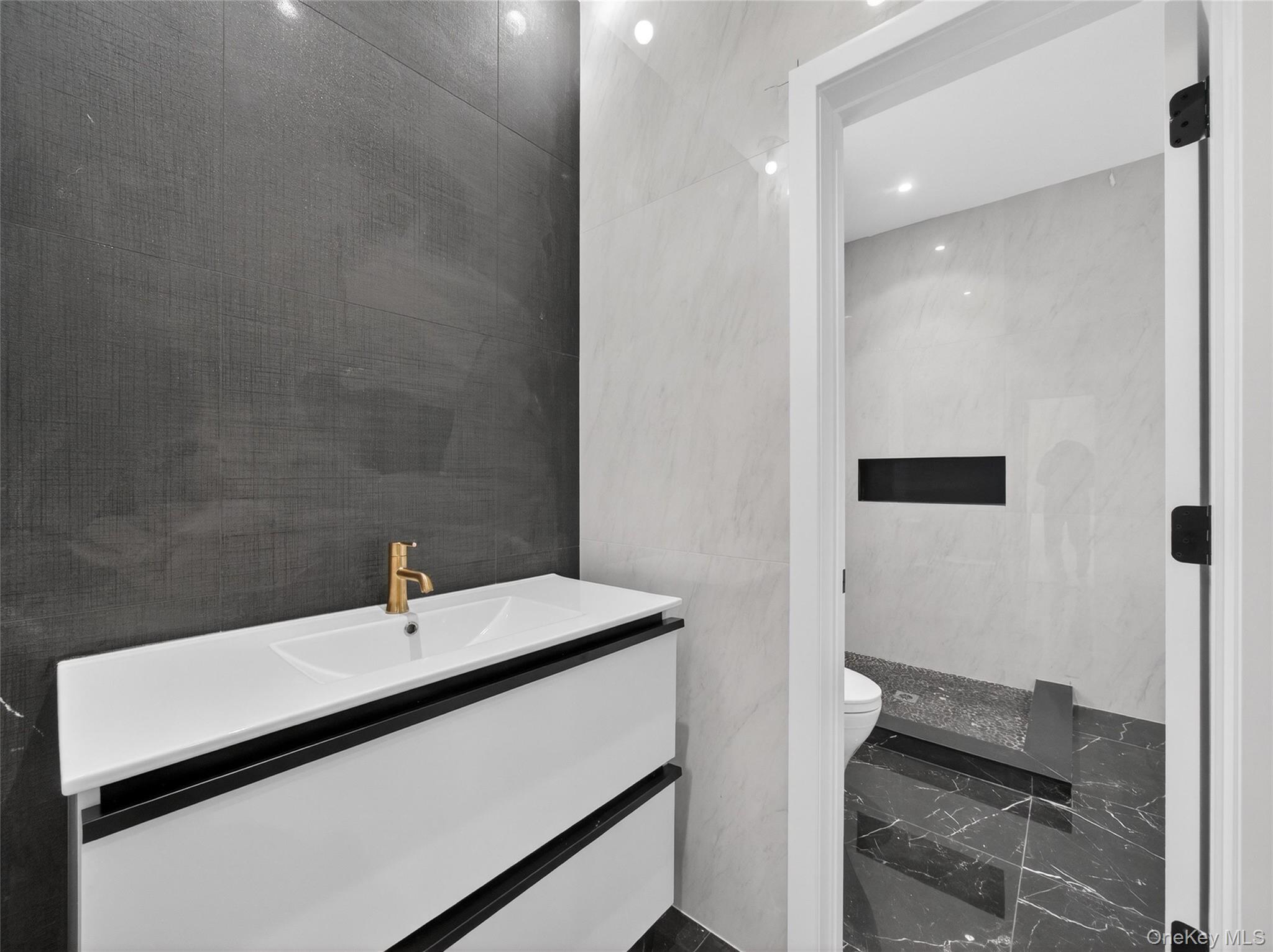 13 Elener Lane, Unit 202 Spring Valley, NY 10977 - Photo 15 of 48 a bathroom with a sink and a mirror