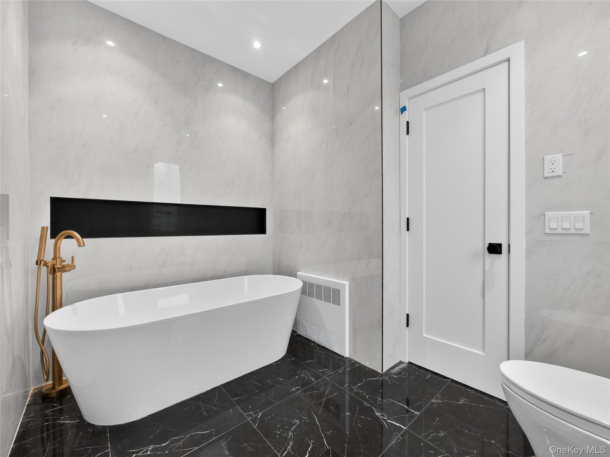 13 Elener Lane, Unit 202 Spring Valley, NY 10977 - Photo 17 of 48 a bathroom with a bathtub and toilet