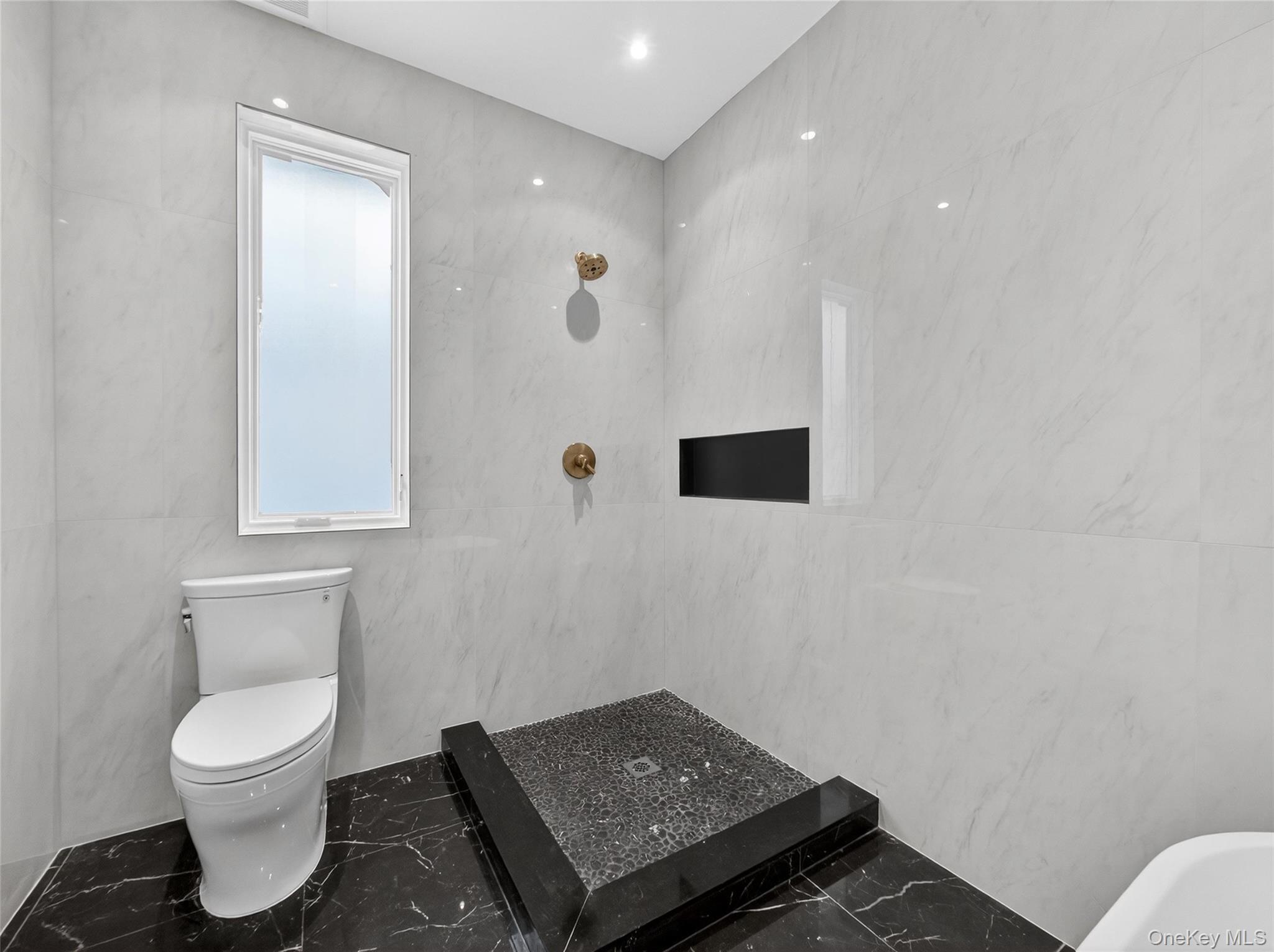 13 Elener Lane, Unit 202 Spring Valley, NY 10977 - Photo 18 of 48 a bathroom with a toilet sink and mirror
