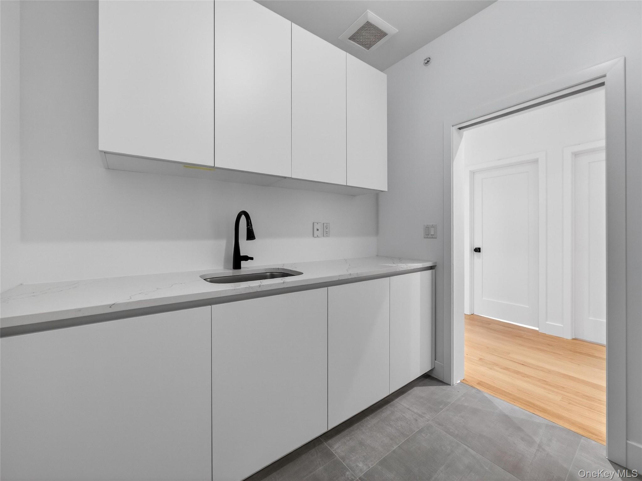 13 Elener Lane, Unit 202 Spring Valley, NY 10977 - Photo 19 of 48 a kitchen with a sink and cabinets