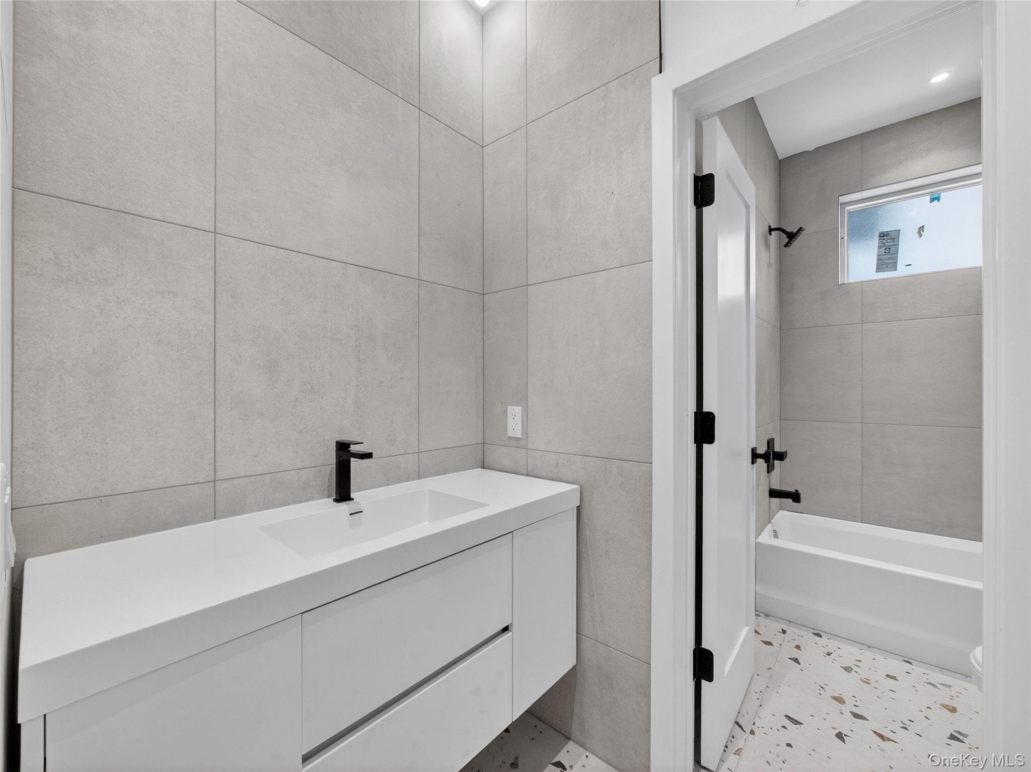 13 Elener Lane, Unit 202 Spring Valley, NY 10977 - Photo 22 of 48 a bathroom with a sink a toilet and shower