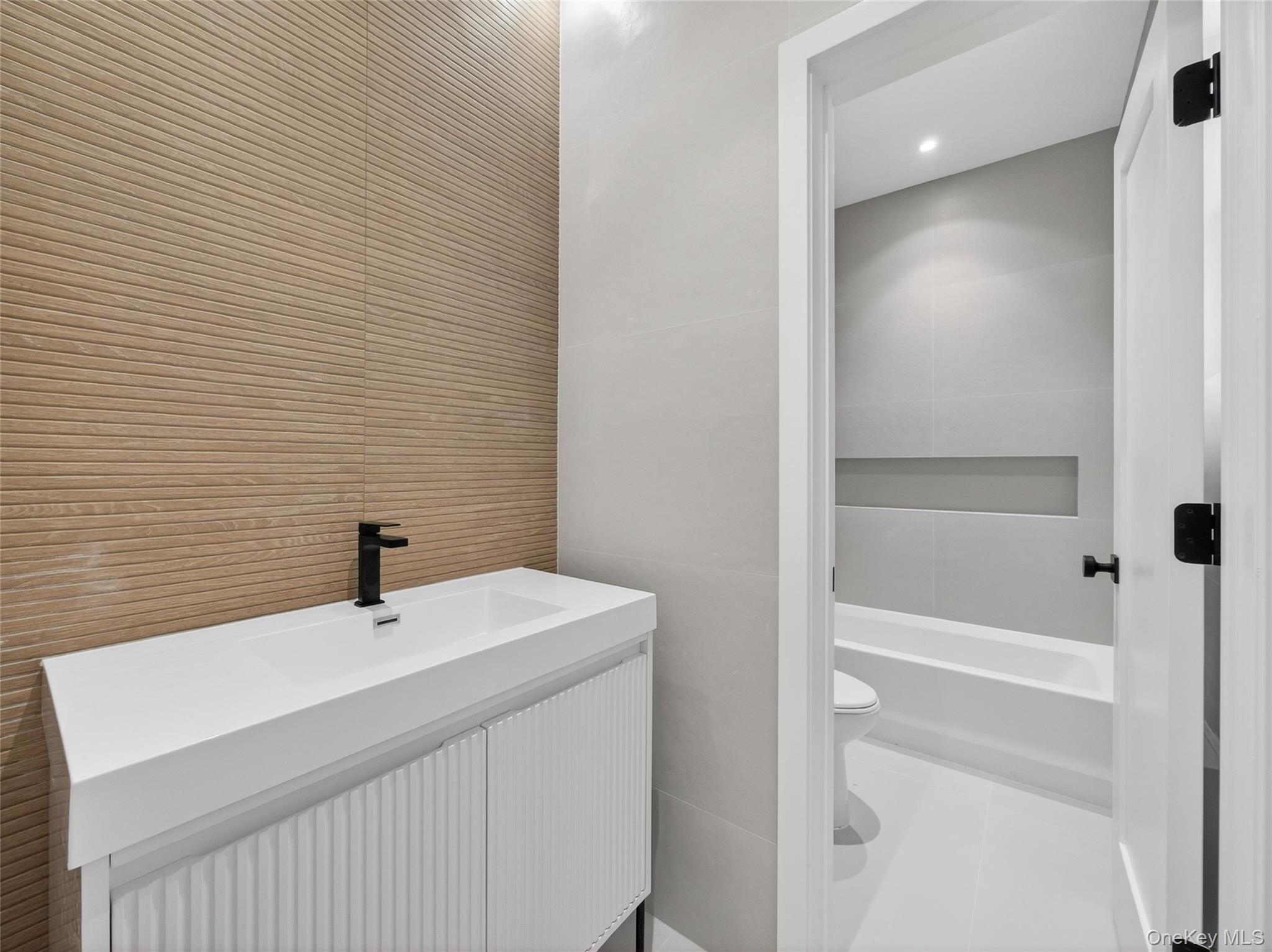 13 Elener Lane, Unit 202 Spring Valley, NY 10977 - Photo 27 of 48 a bathroom with a sink a toilet and shower
