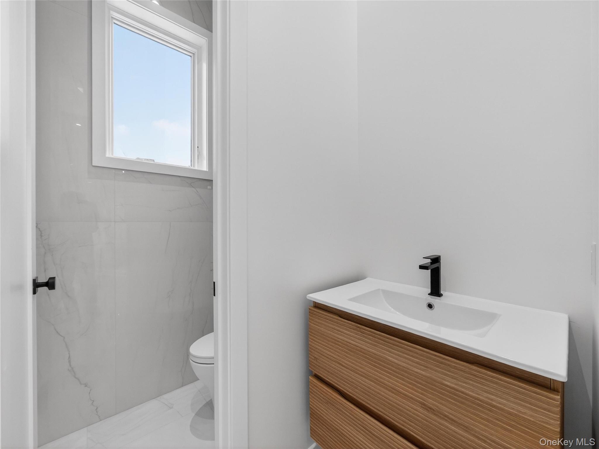 13 Elener Lane, Unit 202 Spring Valley, NY 10977 - Photo 33 of 48 a bathroom with a sink a toilet and shower