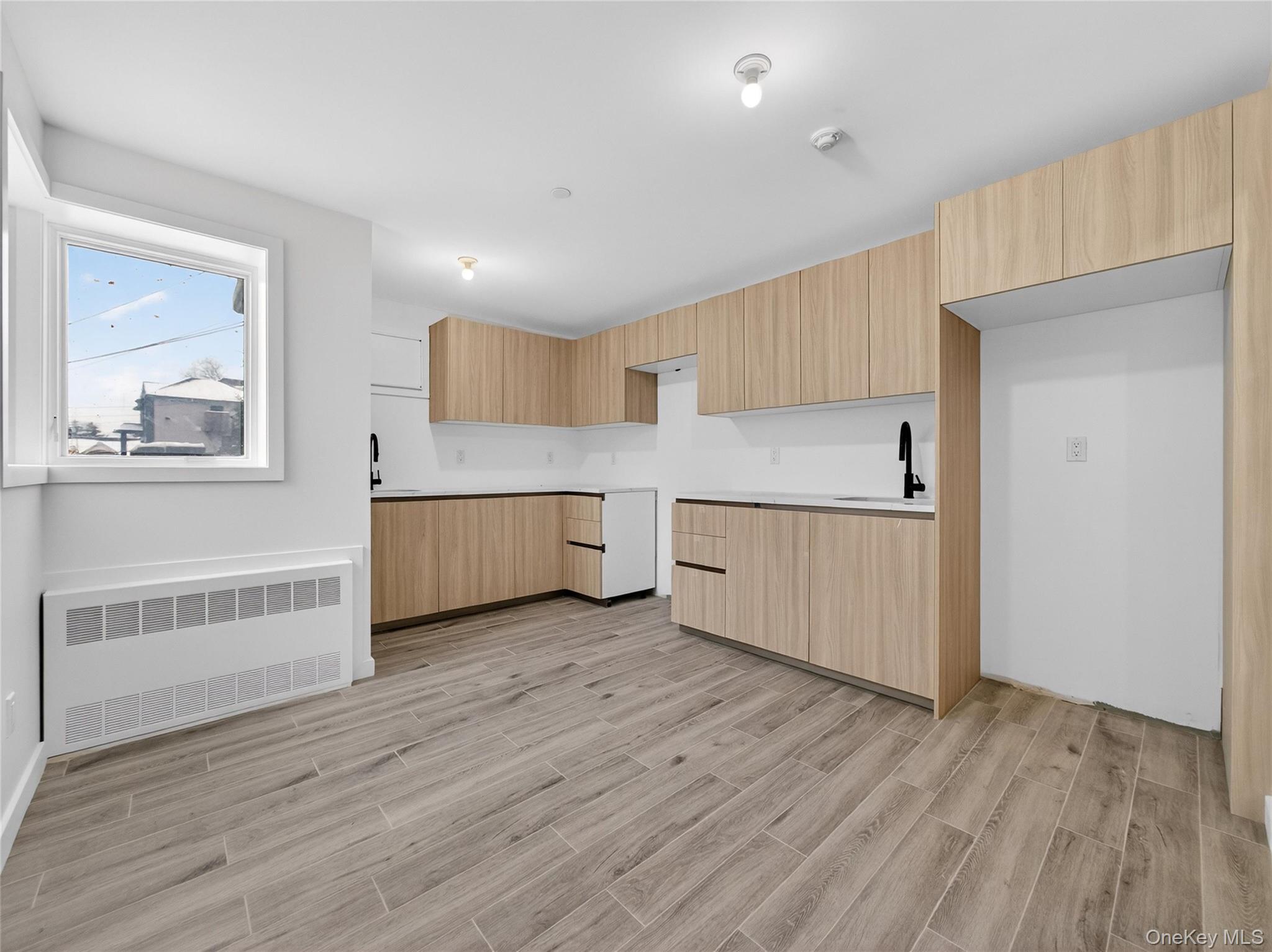 13 Elener Lane, Unit 202 Spring Valley, NY 10977 - Photo 38 of 48 a view of a kitchen with wooden floor and a sink