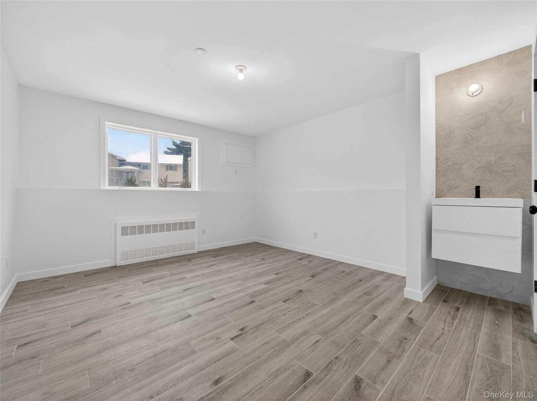 13 Elener Lane, Unit 202 Spring Valley, NY 10977 - Photo 42 of 48 wooden floor in an empty room with a window