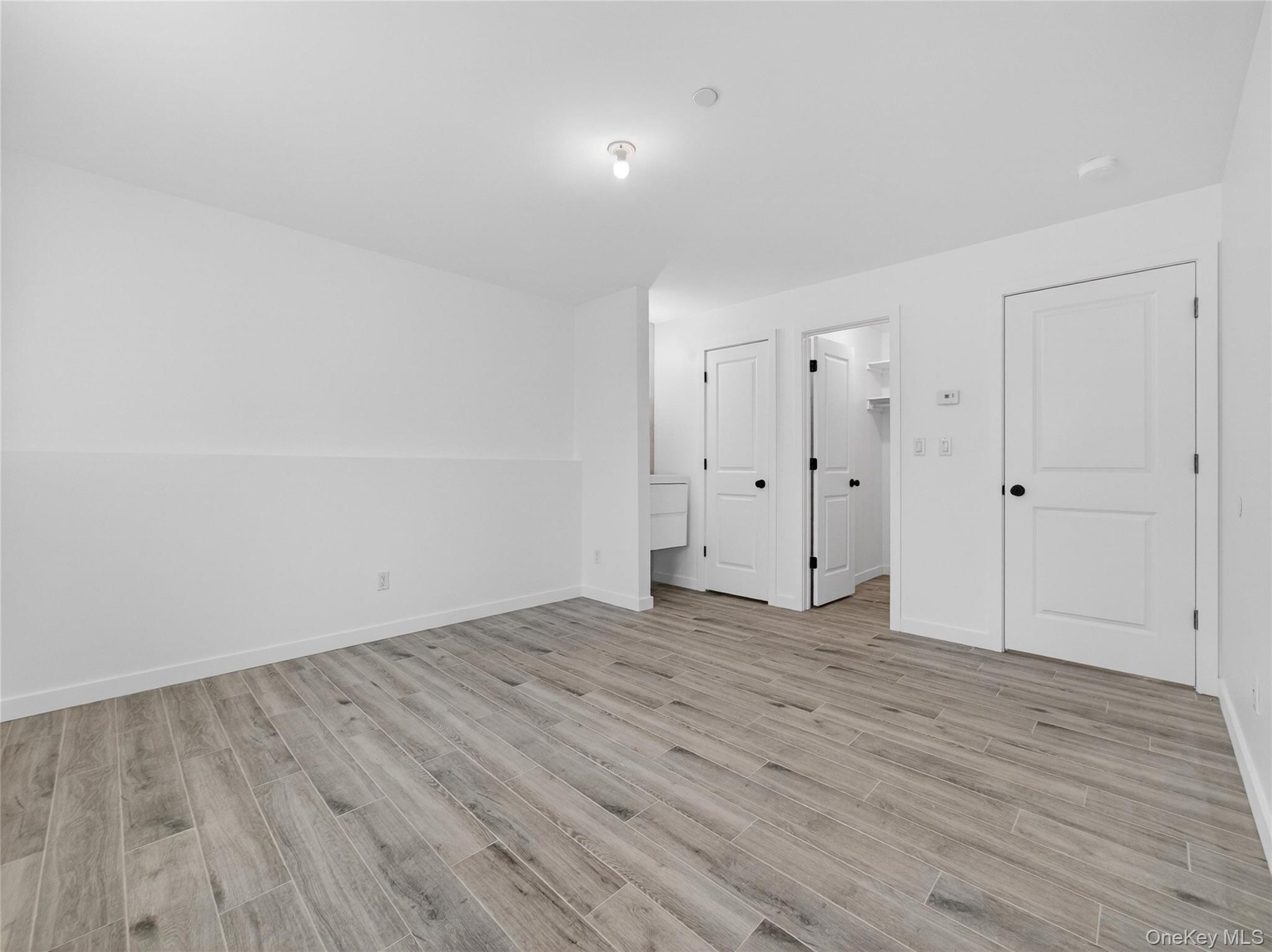 13 Elener Lane, Unit 202 Spring Valley, NY 10977 - Photo 43 of 48 a view of an empty room with wooden floor