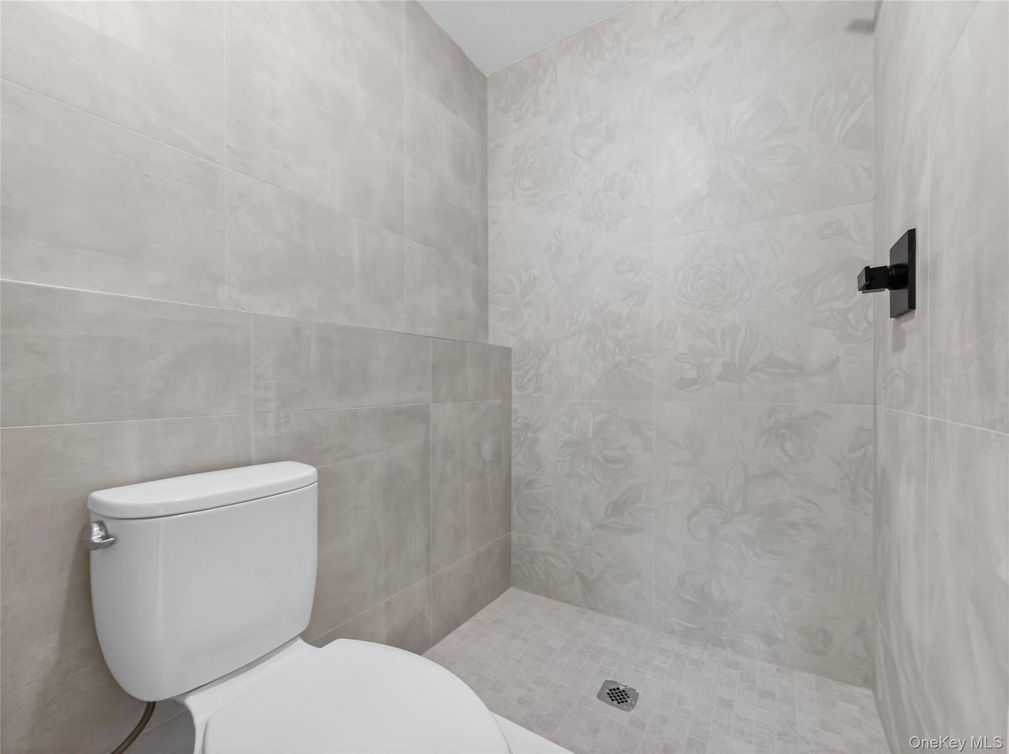 13 Elener Lane, Unit 202 Spring Valley, NY 10977 - Photo 44 of 48 a white toilet sitting next to a shower