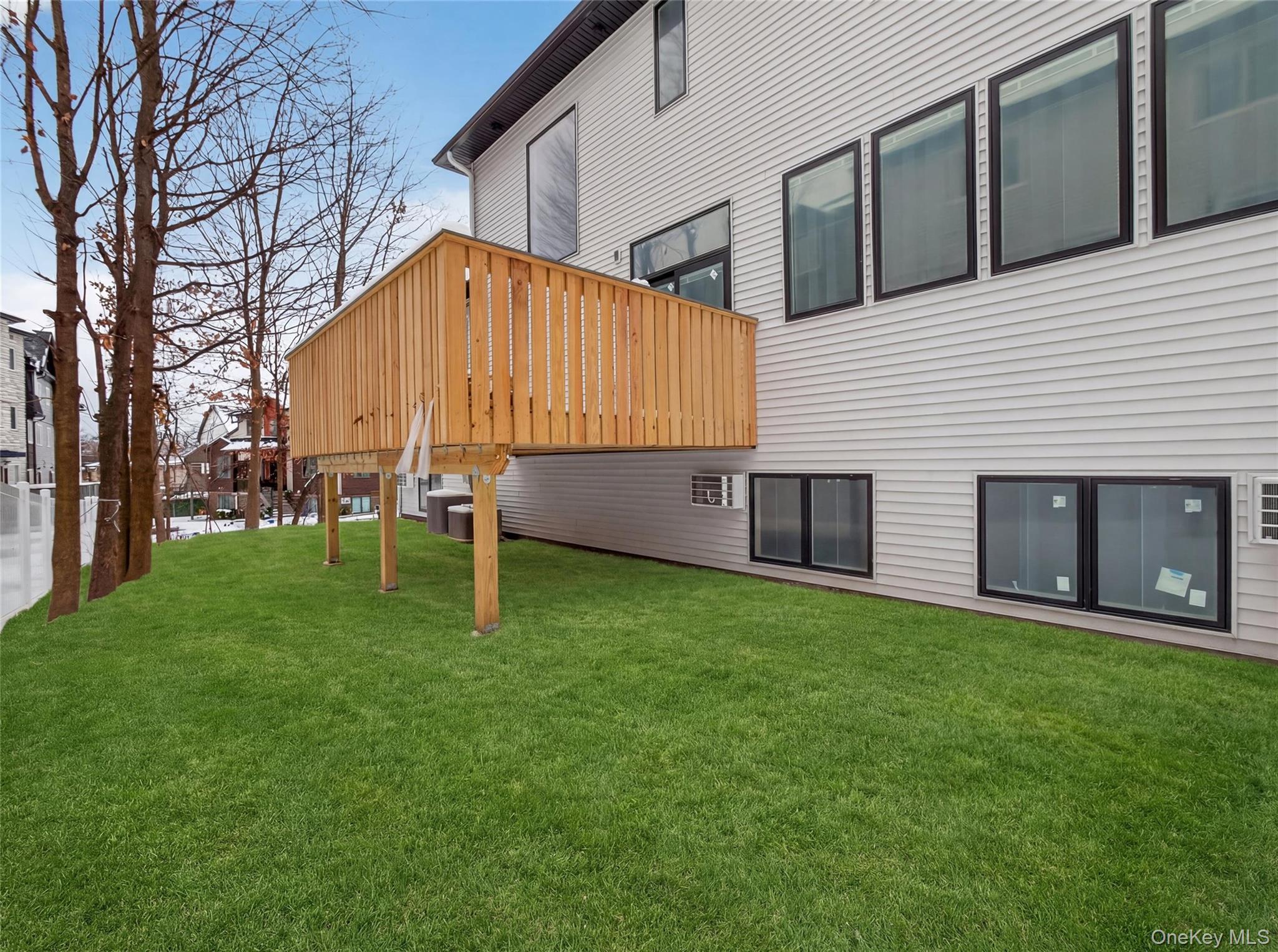 13 Elener Lane, Unit 202 Spring Valley, NY 10977 - Photo 45 of 48 a backyard of a house with table and chairs