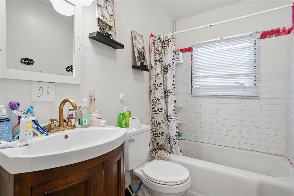 3329 Cumberland Avenue Waco, TX 76708 - Photo 6 of 8 a bathroom with a sink a toilet and shower