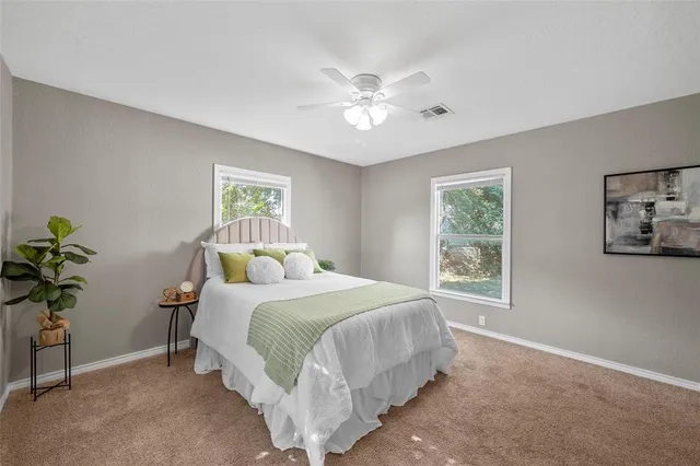 a bedroom with a large bed and a window