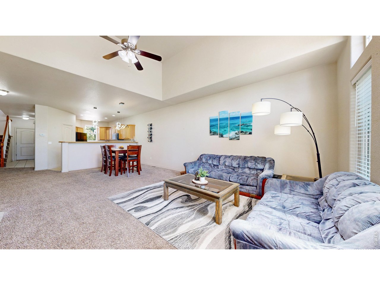 4672 West 20th Road, Unit 413 Greeley, CO 80634 - Photo 11 of 37 a living room with furniture and a large mirror