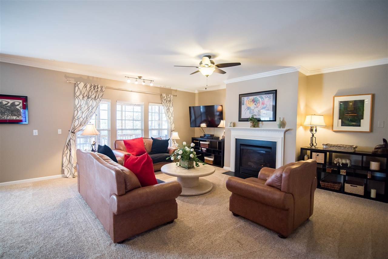 2307 Bright Future Way Raleigh, NC 27614 - Photo 5 of 23 The family room features fireplace, triple windows with backyard view and new Stain Master carpet. Family Room