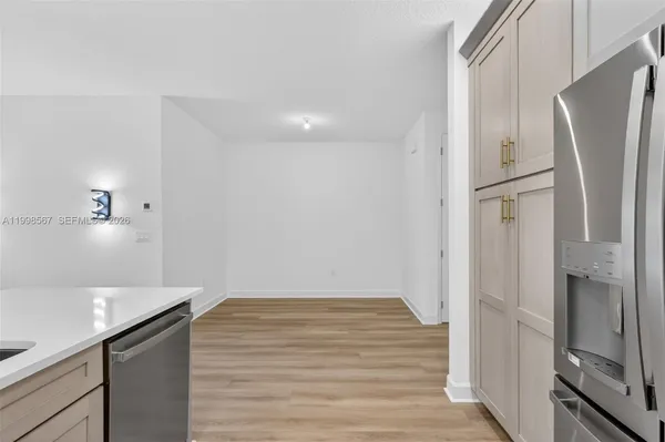 a kitchen with a refrigerator and a sink