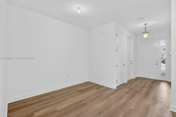 a view of a room with wooden floor