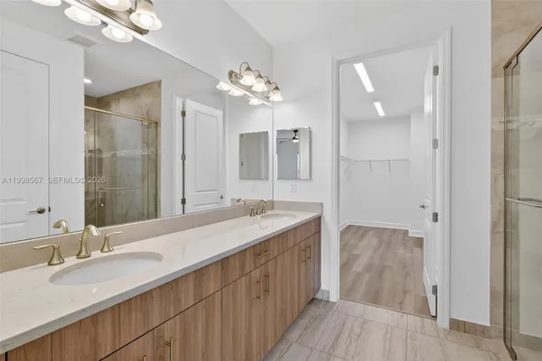 a bathroom with a double vanity sink and a mirror