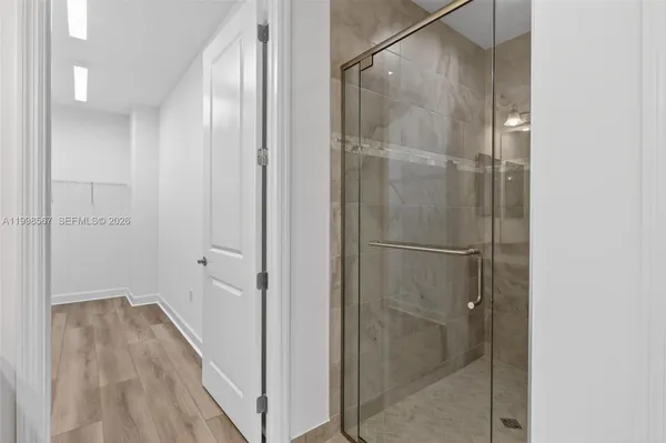 a bathroom with a glass shower door