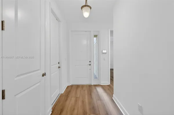 a view of a room with wooden floor and cabinet