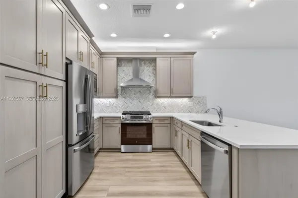 a kitchen with a sink stove and refrigerator