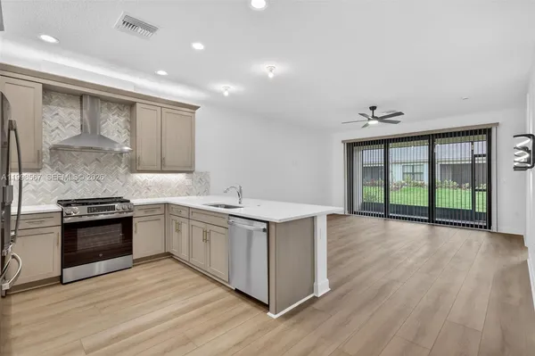 a kitchen with stainless steel appliances granite countertop a stove and a sink