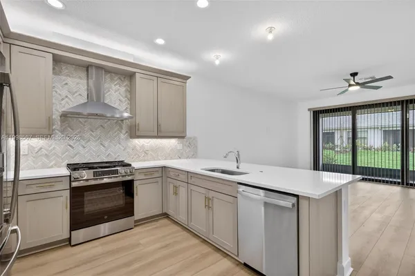 a kitchen with a sink stove and cabinets