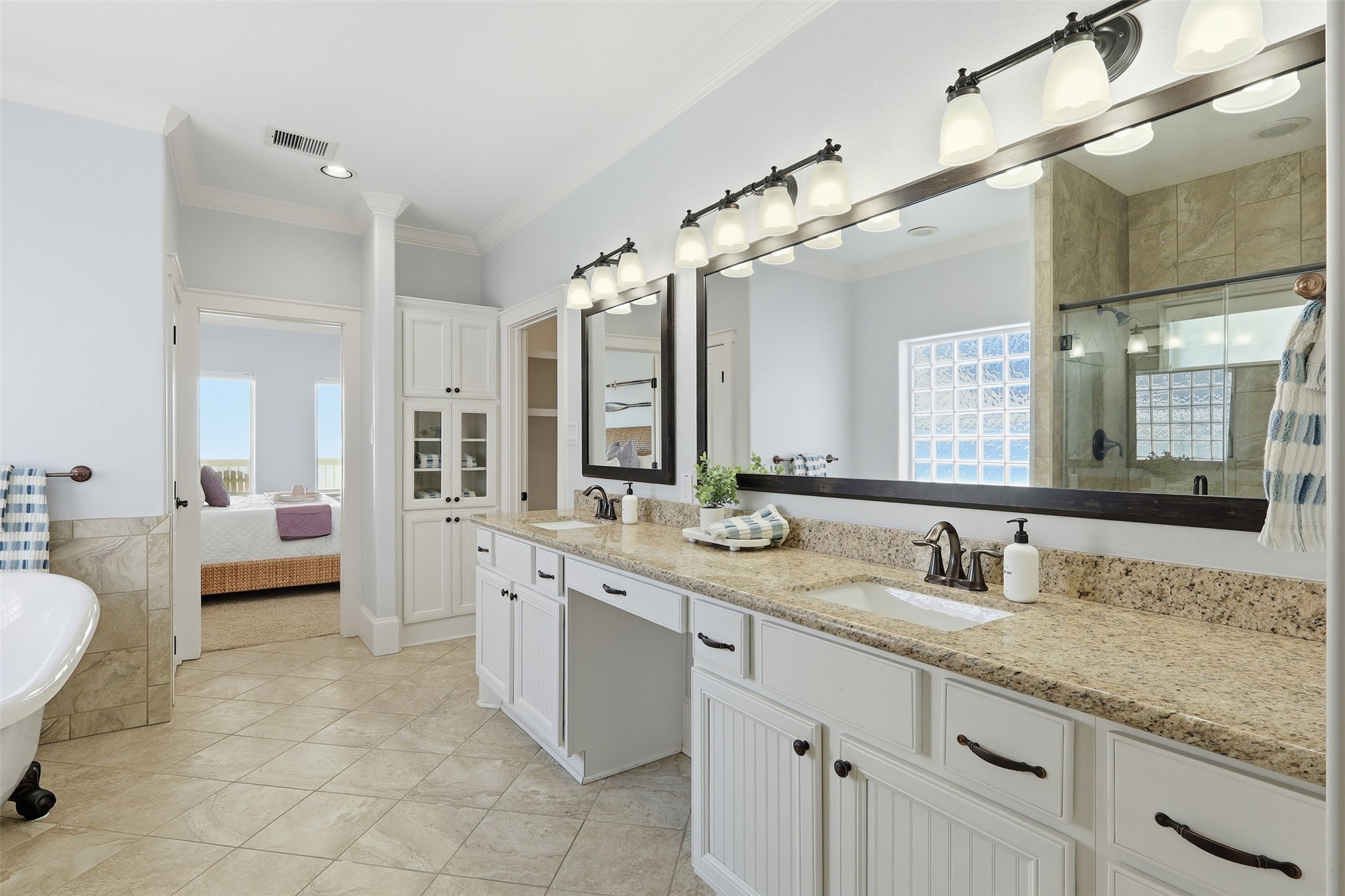 11622 Beachside Galveston, TX 77554 - Photo 15 of 39 This spacious bathroom features dual sinks with granite countertops, ample cabinet storage, and a large mirror all while having direct access to your primary suite.