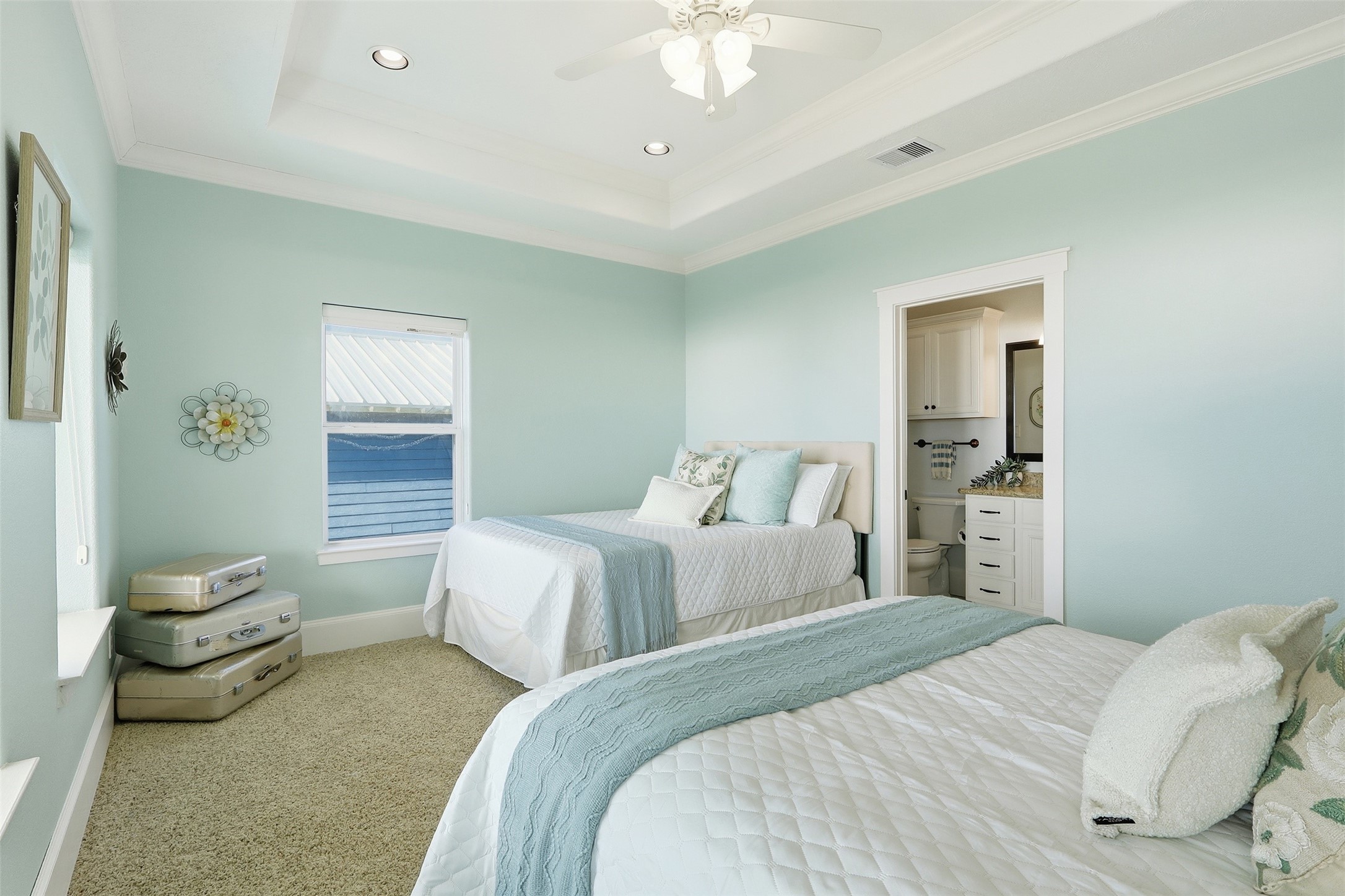 11622 Beachside Galveston, TX 77554 - Photo 17 of 39 This bedroom features a tray ceiling with recessed lighting and an en-suite bathroom. Elegant and serene, ideal for relaxation.