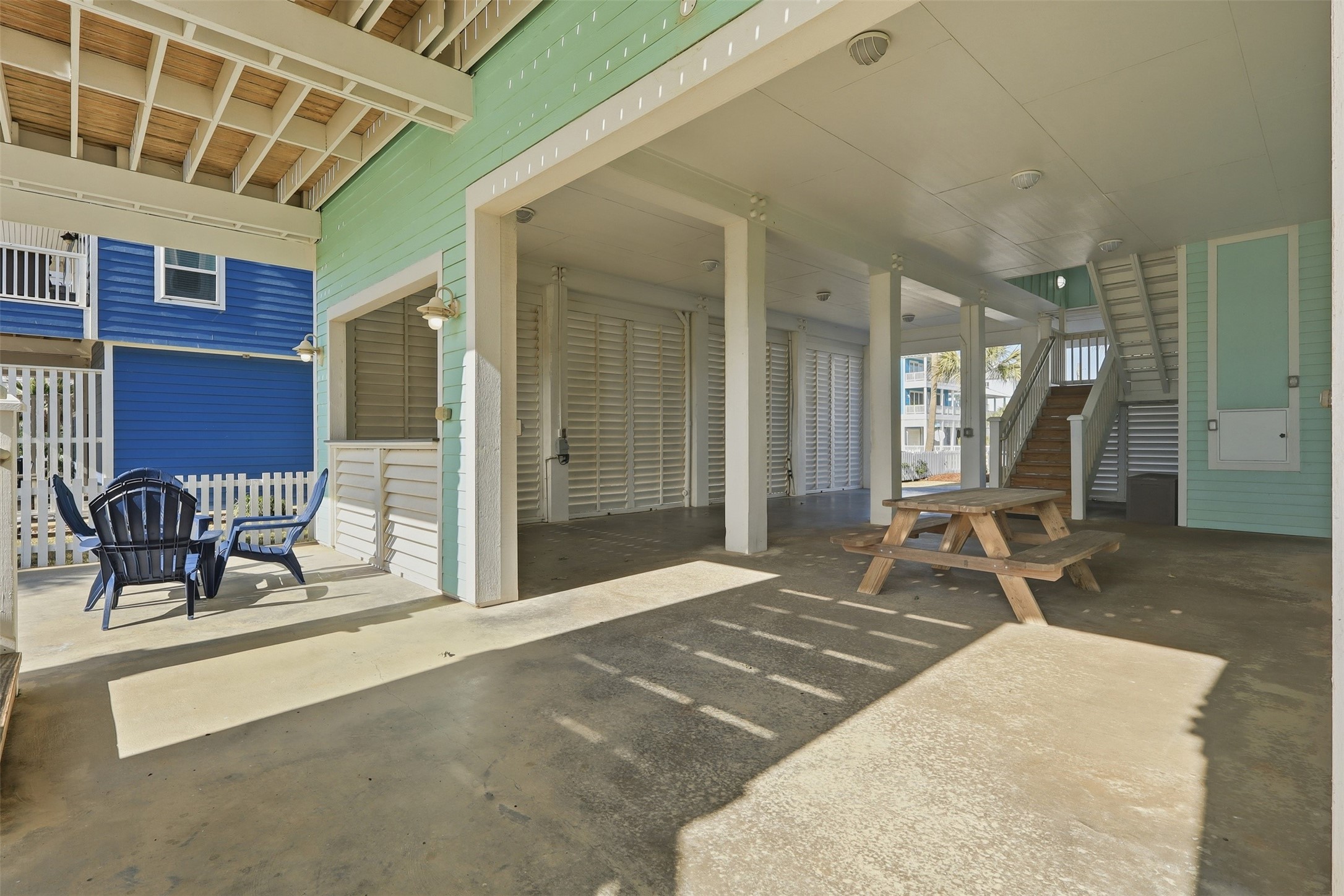 11622 Beachside Galveston, TX 77554 - Photo 29 of 39 A spacious, covered outdoor area with seating and a picnic table, featuring an open design.