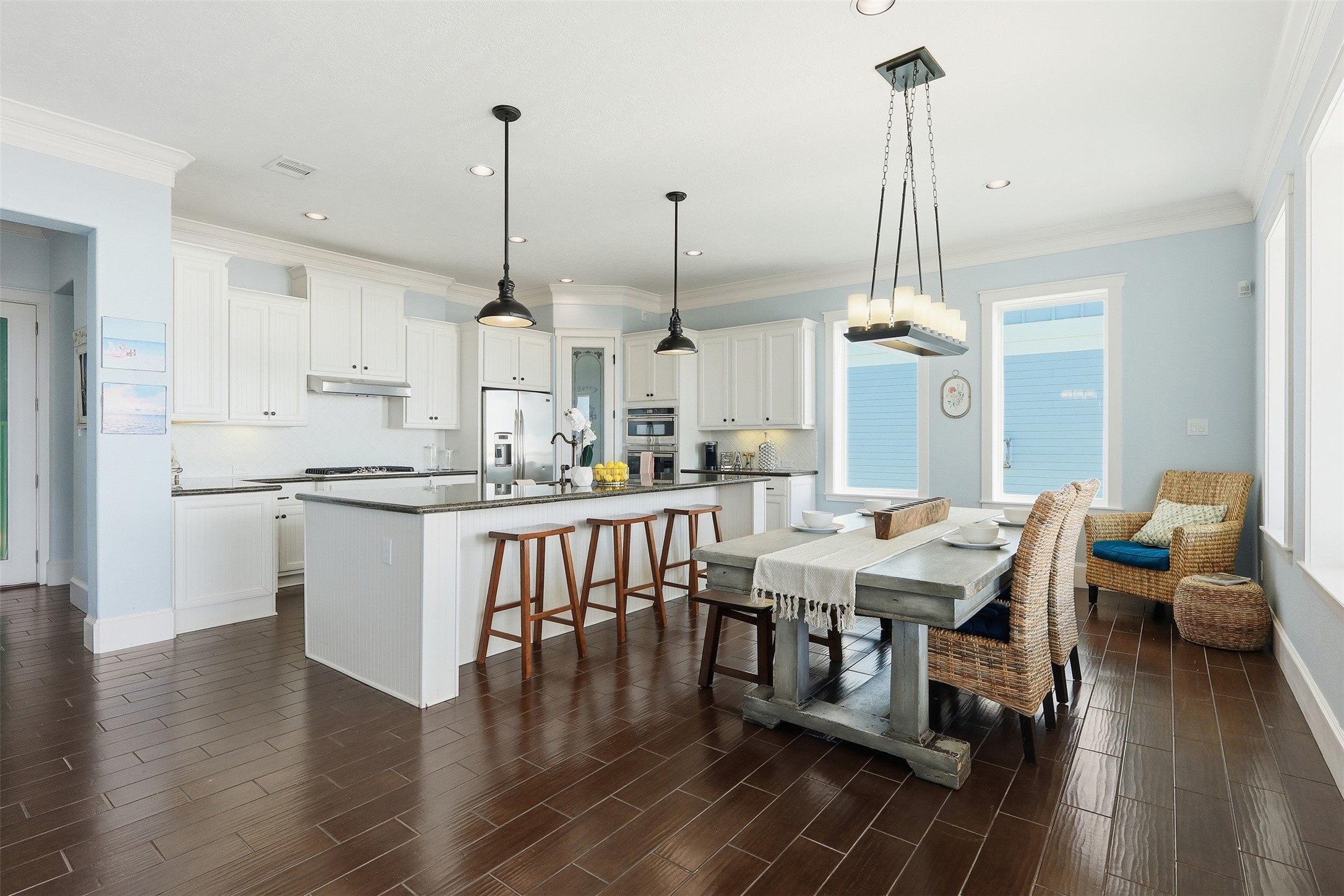 11622 Beachside Galveston, TX 77554 - Photo 4 of 39 This spacious and bright kitchen features modern white cabinetry, stainless steel appliances, and a central island with seating with an adjacent dining area.
