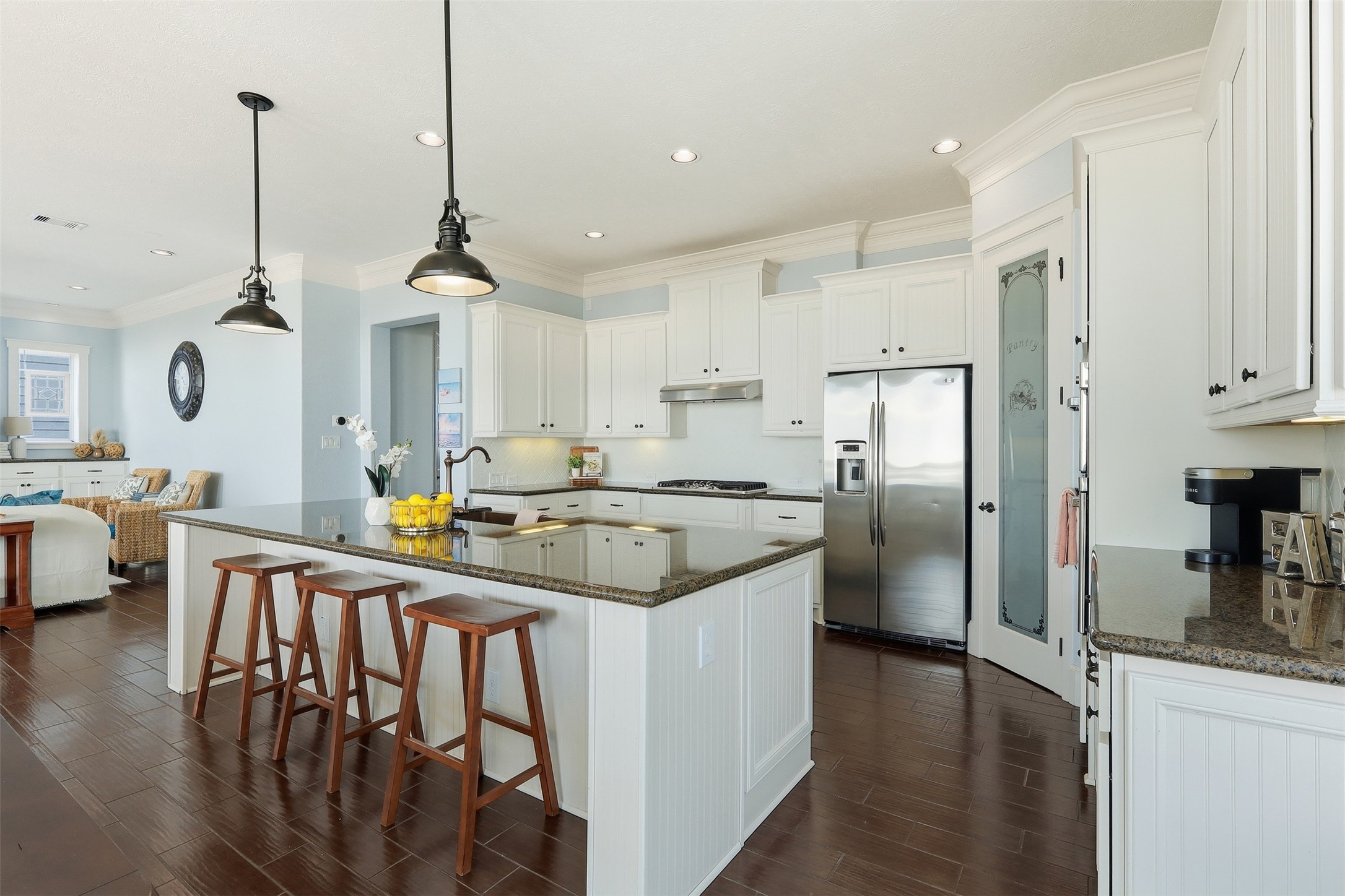 11622 Beachside Galveston, TX 77554 - Photo 6 of 39 This bright kitchen features sleek granite countertops, a large island with seating, stainless steel appliances, and ample white cabinetry.