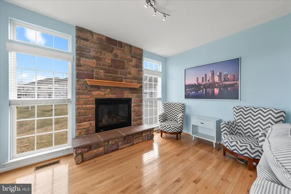 a living room with furniture a dining table and a wooden floor
