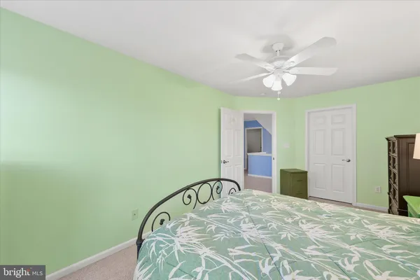 a bedroom with a bed a chandelier and a window