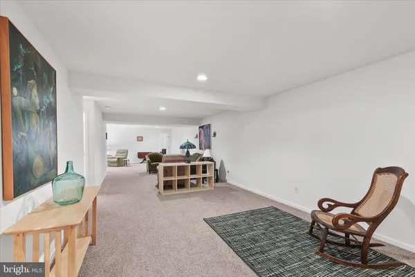 a bedroom with a bed and painting on the wall