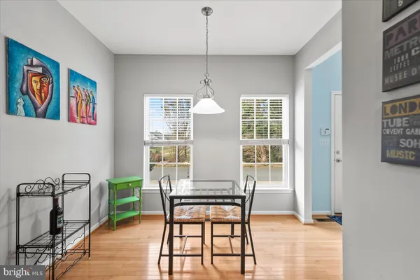 a living room with furniture dining table and a wooden floor