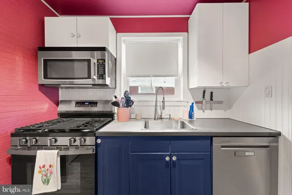 a kitchen with stainless steel appliances granite countertop a refrigerator and a stove