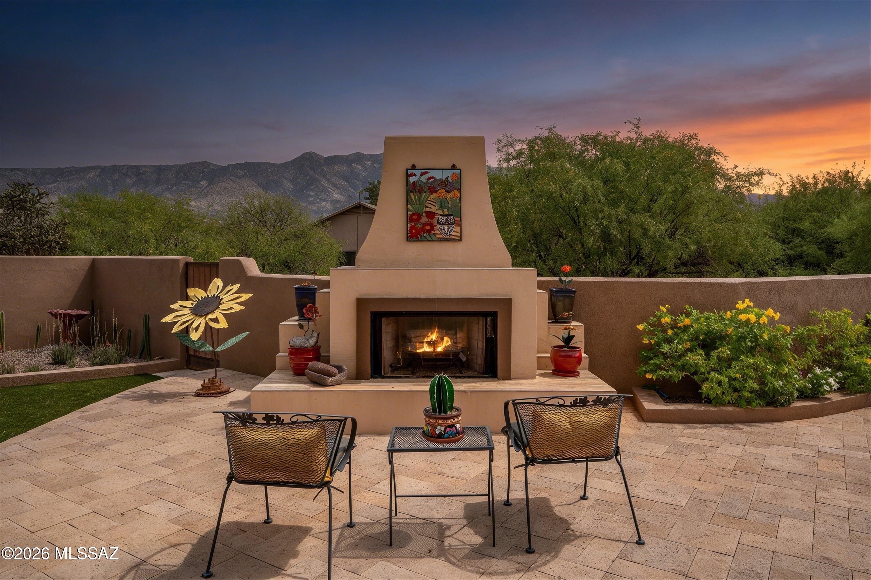 4760 East Wagon Train Road Tucson, AZ 85739 - Photo 6 of 38 a backyard of a house with yard fire pit and outdoor seating