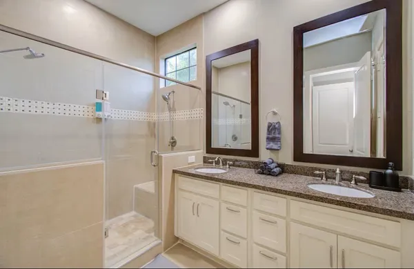a bathroom with a granite countertop sink mirror and double
