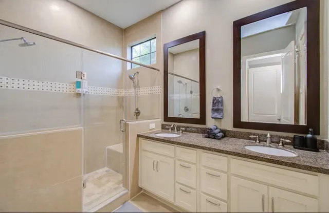 a bathroom with a granite countertop sink mirror and double