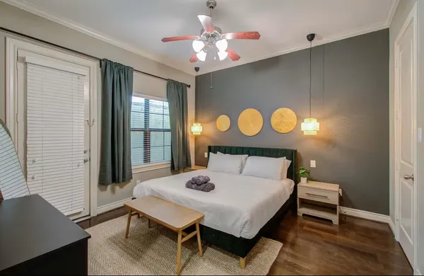 a bedroom with a bed and a chandelier