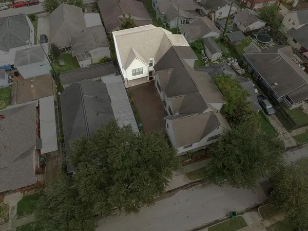 an aerial view of a house with yard and parking