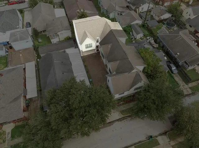 an aerial view of a house with yard and parking