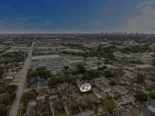 an aerial view of house with yard and mountain view in back