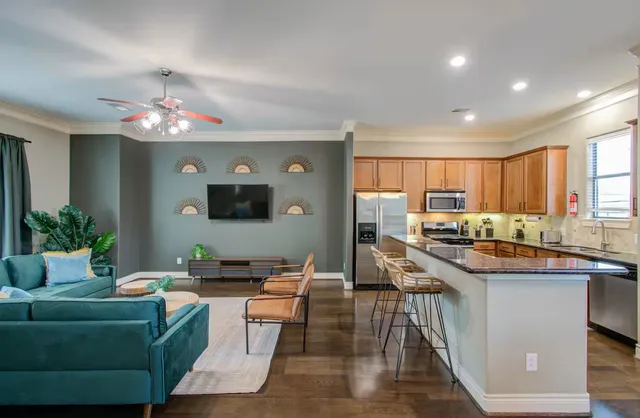 a living room with furniture windows and a flat screen tv