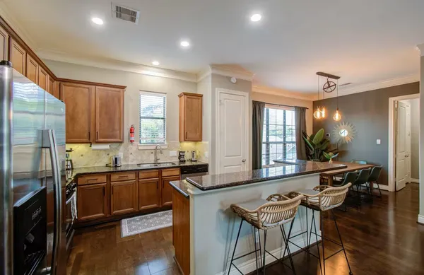 a large kitchen with a table and chairs in it