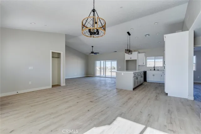 a kitchen with kitchen island white cabinets and refrigerator