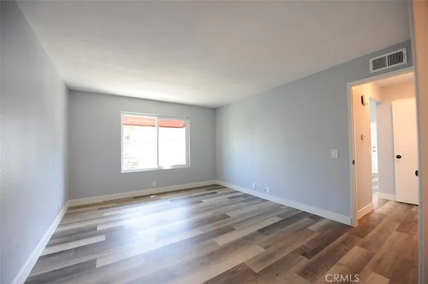 a view of empty room with fireplace and windows