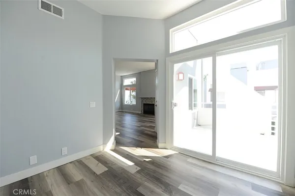 a kitchen with granite countertop white cabinets and stainless steel appliances