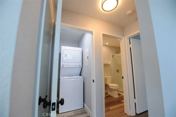 a bathroom with a shower sink vanity mirror and toilet