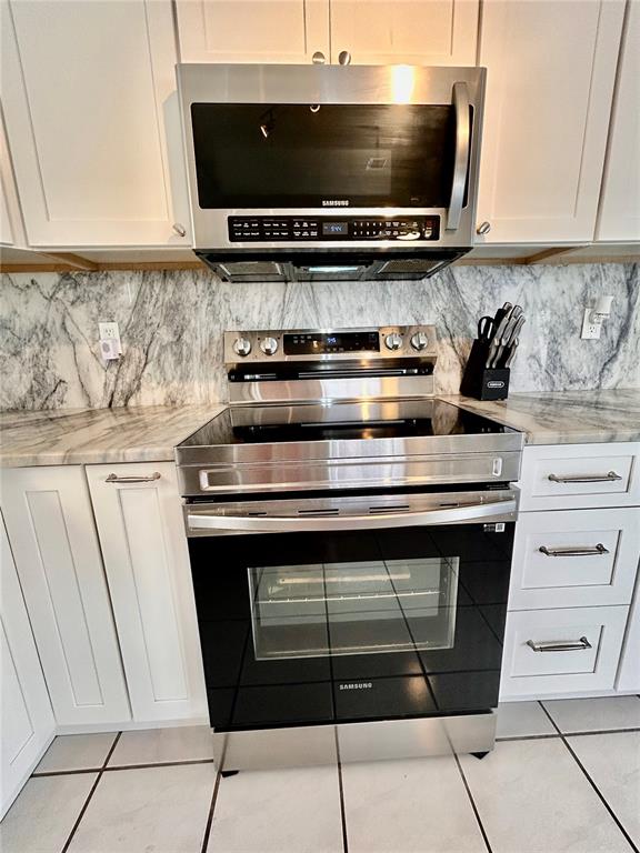 8911 Welsh Way Hudson, FL 34667 - Photo 11 of 33 a stove top oven sitting inside of a kitchen