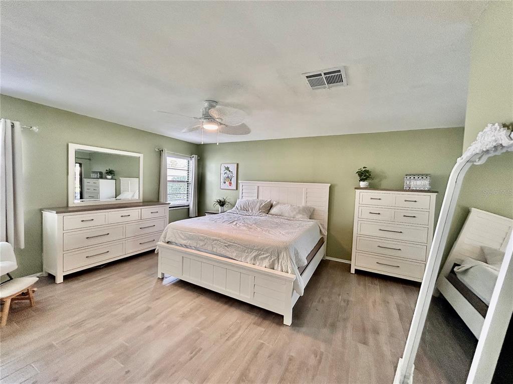 8911 Welsh Way Hudson, FL 34667 - Photo 14 of 33 a bedroom with a bed and a couch
