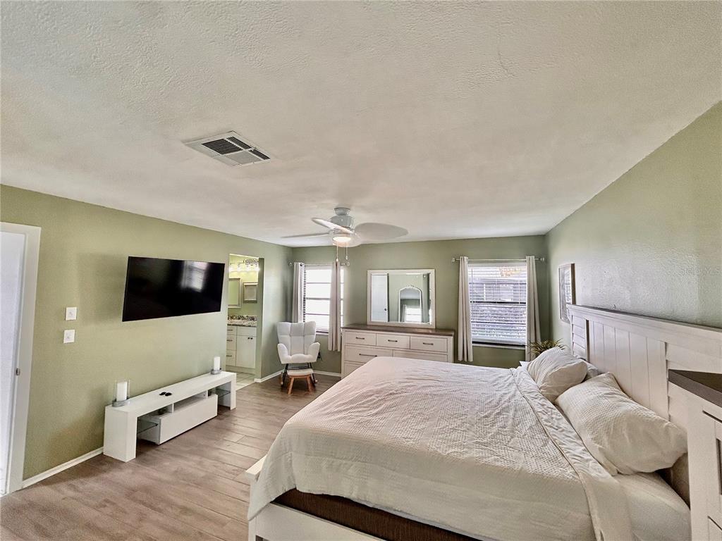 8911 Welsh Way Hudson, FL 34667 - Photo 15 of 33 a bedroom with furniture and a flat screen tv